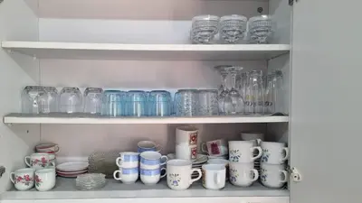 a shelf full of glass jars and other items at Elpida Lemon Garden House in Limassol