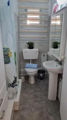 a small bathroom with a toilet and a sink at Elpida Lemon Garden House in Limassol