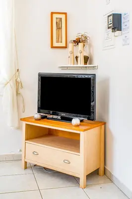 a flat screen tv sitting on a wooden stand at Villa Sunnyside Mandali by Ezoria Villas in Protaras