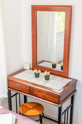a mirror on a dresser with potted plants on it at Villa Sunnyside Mandali by Ezoria Villas in Protaras