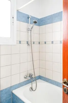 a shower in a bathroom with blue and white tiles at Villa Sunnyside Mandali by Ezoria Villas in Protaras