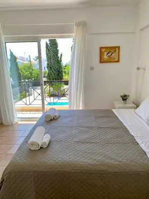 a bedroom with a large bed with towels on it at Villa Lorena Protaras in Protaras