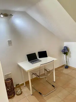 a white desk with two laptops on top of it at Villa Lorena Protaras in Protaras