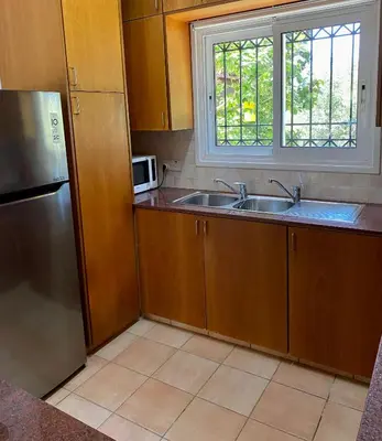 a kitchen with a sink and a microwave at Villa Lorena Protaras in Protaras