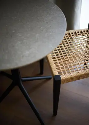 a table and a wicker chair next to a table at Alinea Primo Historic Center in Limassol