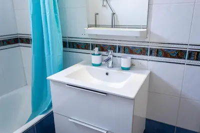 a bathroom with a white sink and a mirror at Seaview Harmony in Larnaka