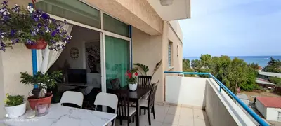 a balcony of a house with a table and chairs at Seaview Harmony in Larnaka