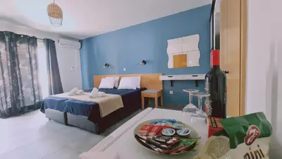 a hotel room with a bed and a table with a bowl of food at Nissi avenue 64 Studio 2 - Luxcyservices in Ayia Napa