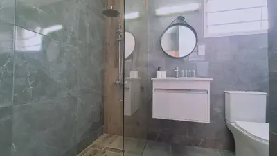a bathroom with a shower and a toilet and a mirror at Nissi avenue 64 Studio 2 - Luxcyservices in Ayia Napa
