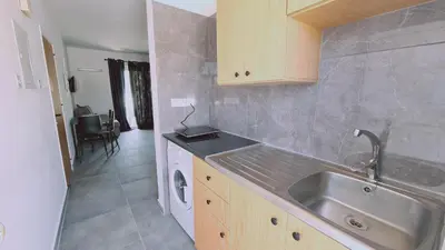 a kitchen with a sink and a washing machine at Nissi avenue 64 Studio 2 - Luxcyservices in Ayia Napa