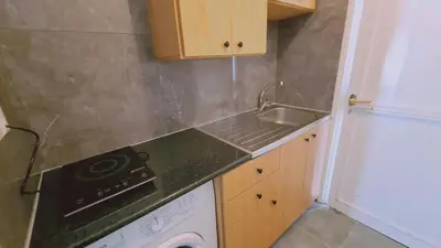 a small kitchen with a sink and a dishwasher at Nissi avenue 64 Studio 2 - Luxcyservices in Ayia Napa