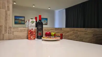 a table with two bottles of wine and a plate of food at STAY Lavish Studio in Ayia Napa
