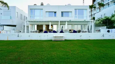 a white house with a lawn in front of it at Narcissus 19 in Paralimni