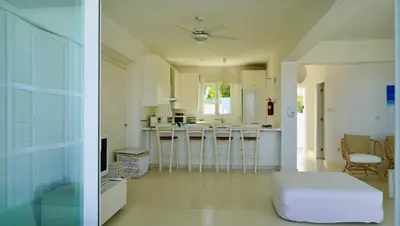 two pictures of a kitchen and a living room at Narcissus 18 in Paralimni
