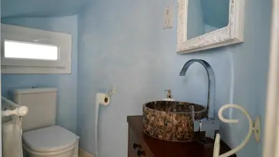 a bathroom with a sink and a toilet and a mirror at Narcissus 18 in Paralimni