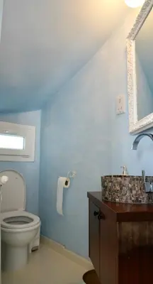 a bathroom with a toilet and a sink and a mirror at Narcissus 18 in Paralimni
