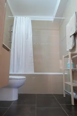 a bathroom with a shower and a toilet and a tub at Mythical Sands AM10 in Paralimni