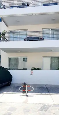 a skateboard parked in a parking lot in front of a building at Mythical Sands AM10 in Paralimni