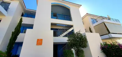 a white apartment building with a sign on it at Mythical Sands AM10 in Paralimni