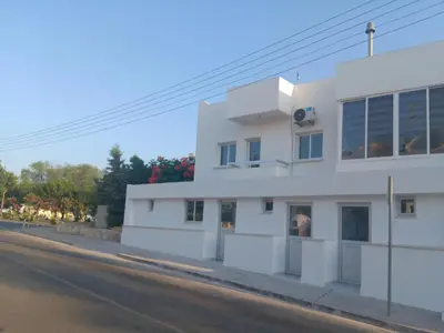 a white building on the side of a street at PoliaNapa Nest in Ayia Napa