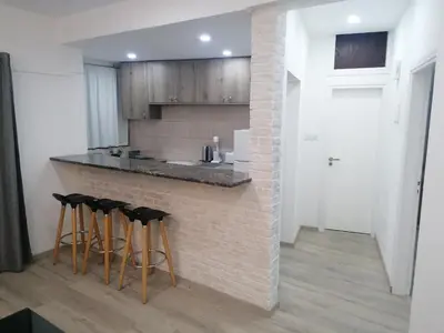a kitchen with a counter with bar stools at PoliaNapa Nest in Ayia Napa
