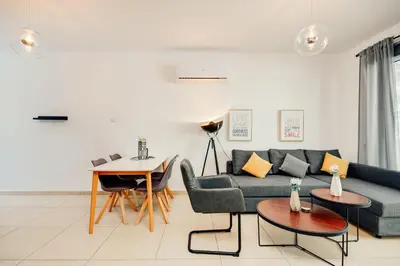 a living room with a couch and a table at SunnyVillas: 2BR Mythical Apt*Swimming Pool*AK04 in Paralimni