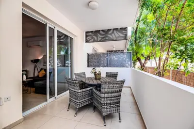 a dining room with a table and chairs on a balcony at SunnyVillas: 2BR Mythical Apt*Swimming Pool*AK04 in Paralimni