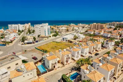 an aerial view of a city with buildings and the ocean at Villa Sunrise Pernera in Paralimni