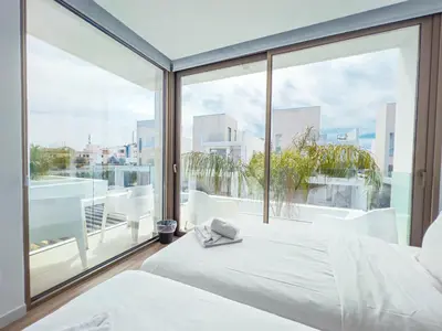 a bedroom with two beds and a large window at Azure Seaview - Jade Villa in Protaras