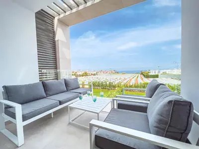 a living room with a couch and a view of the ocean at Azure Seaview - Jade Villa in Protaras