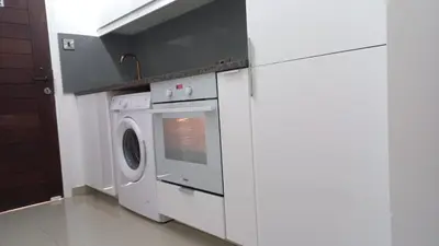 a kitchen with a white washer and dryer at Modern Studio apartment Armonia Court in Paralimni