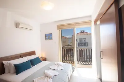 a bedroom with a bed and a large window at Sunny Side Up Villa in Protaras