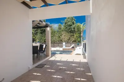 an external view of a house with a patio and a swimming pool at Sunny Side Up Villa in Protaras