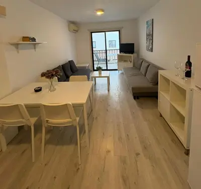 a living room with a table and a couch at Theodoros Apt.79 in Paralimni