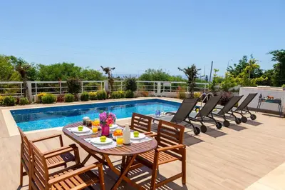 a patio with a table and chairs next to a pool at Napa Bay View Villa 3 in Ayia Napa