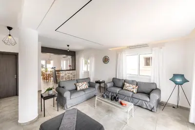 a living room with two couches and a fireplace at Napa Bay View Villa 3 in Ayia Napa