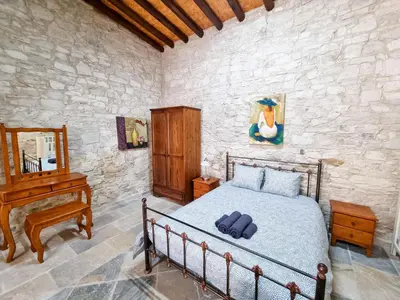 a bedroom with a bed and a piano in a room at Aphrodite's Pool Retreat in Skarinou