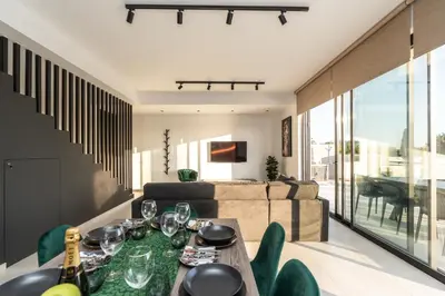a living room with a table and a couch at Tsiolakki Homes Luxury Villas in Protaras