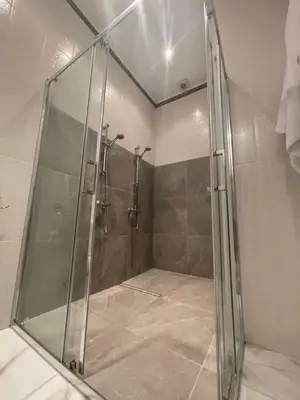 a shower with a glass door in a bathroom at Maestro Sea - View Apartment in Larnaka