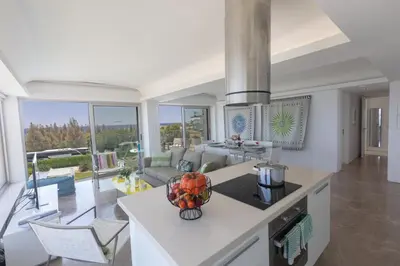 a kitchen and living room with a view of a living room at Thalassa Luxury Apartment in Protaras