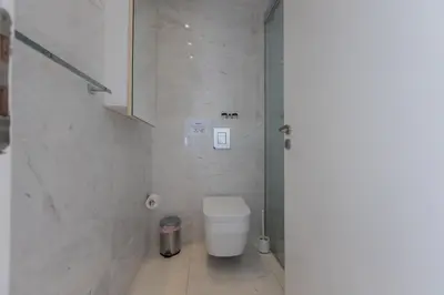 a white bathroom with a toilet and a sink at Thalassa Luxury Apartment in Protaras