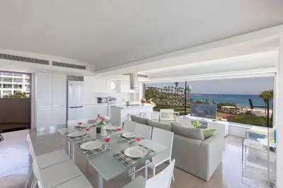 a kitchen and dining room with a table and chairs at Thalassa Luxury Apartment in Protaras