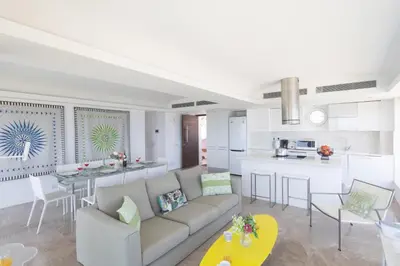 a living room with a couch and a kitchen at Thalassa Luxury Apartment in Protaras