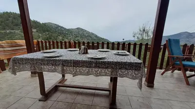 a table sitting on a balcony with a table cloth at Mountain View 2BR House with Garden & Free Parking Ioannis Ylation Saranti in Nicosia