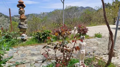 a garden with a statue in the middle of a path at Mountain View 2BR House with Garden & Free Parking Ioannis Ylation Saranti in Nicosia