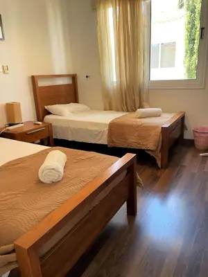 a hotel room with two beds and a window at Villa Flory in Protaras