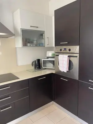 a kitchen with black and white cabinets and appliances at Villa Flory in Protaras