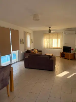 a living room with a couch and a tv at Villa Flory in Protaras